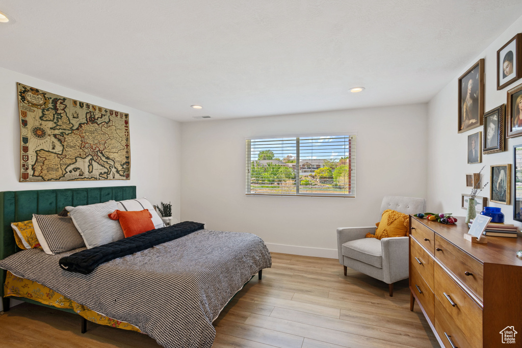 Bedroom with light wood-style flooring, recessed lighting, and baseboards
