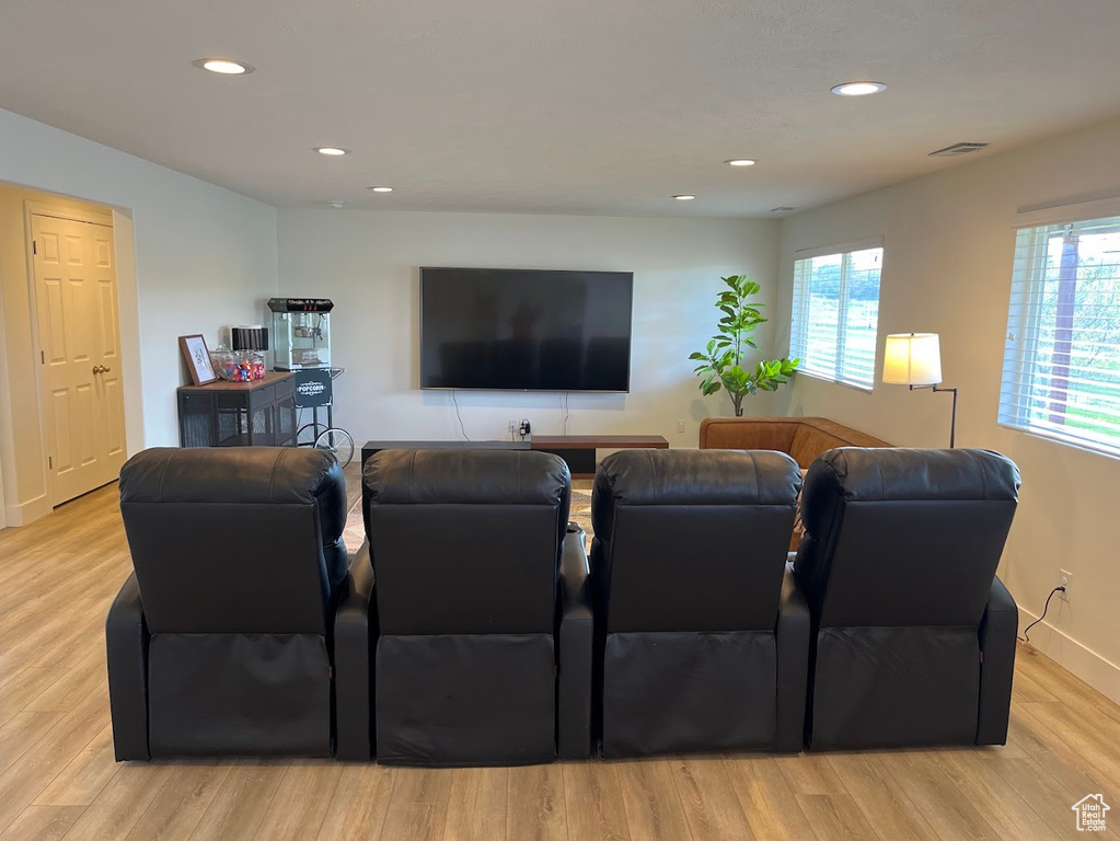 Living room featuring recessed lighting, baseboards, visible vents, and light wood-type flooring