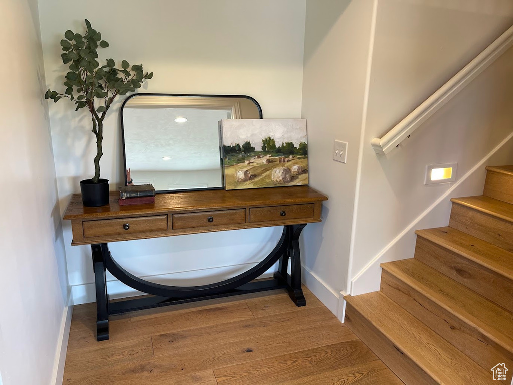 Interior space featuring baseboards, stairs, and wood finished floors