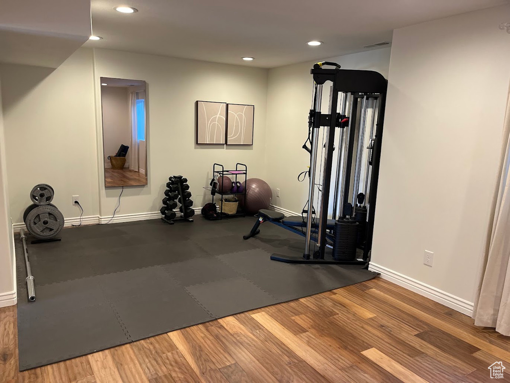 Workout room with baseboards, recessed lighting, and wood finished floors