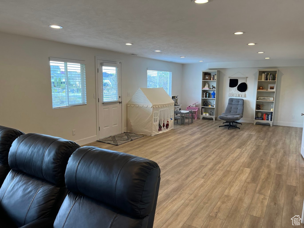 Playroom with a healthy amount of sunlight, recessed lighting, and wood finished floors