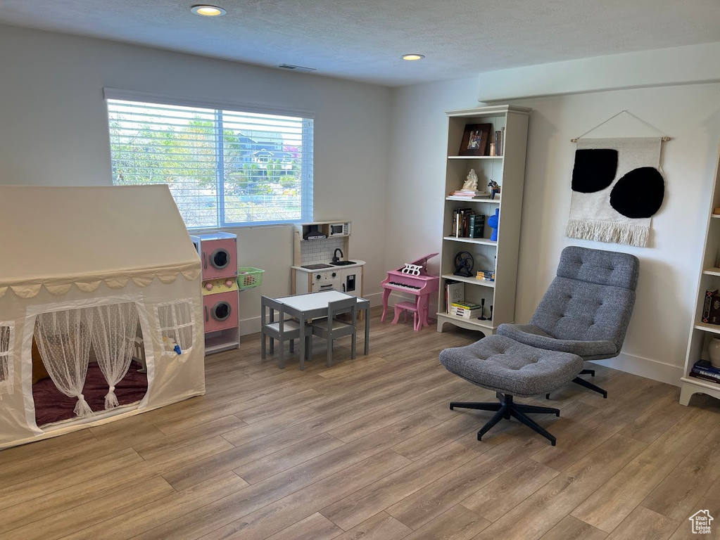 Game room with recessed lighting, visible vents, and light wood finished floors