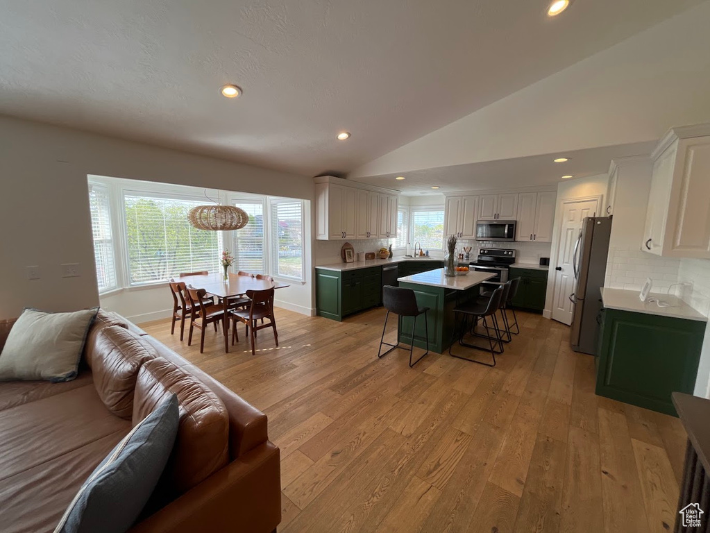 Interior space featuring recessed lighting, vaulted ceiling, and light wood-type flooring