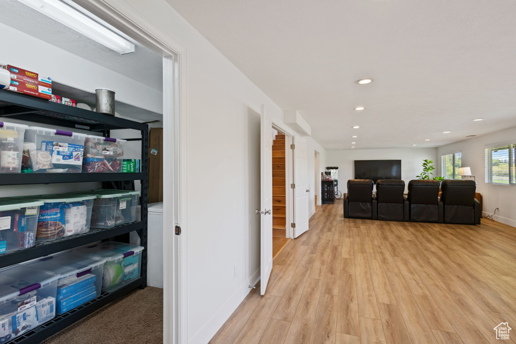 Living area featuring light wood-style flooring, recessed lighting, and baseboards
