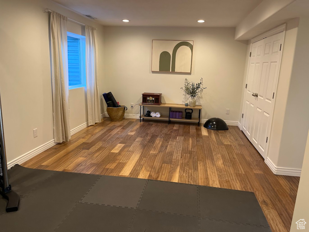 Interior space featuring baseboards, recessed lighting, and wood finished floors