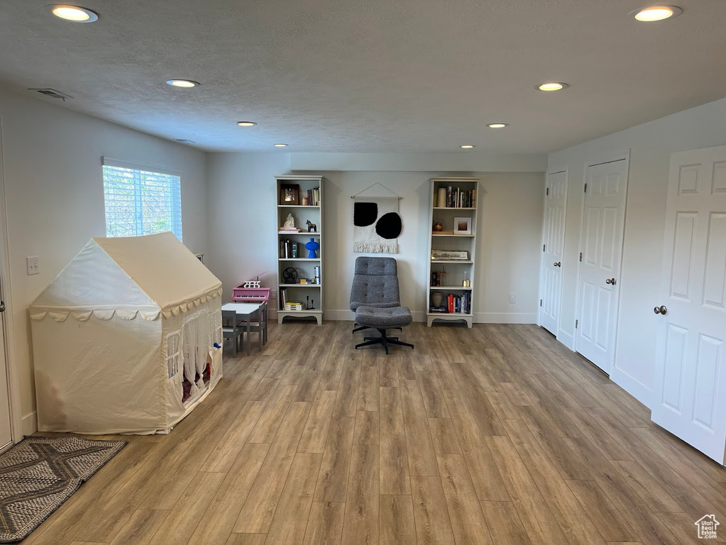 Interior space with recessed lighting, wood finished floors, and visible vents