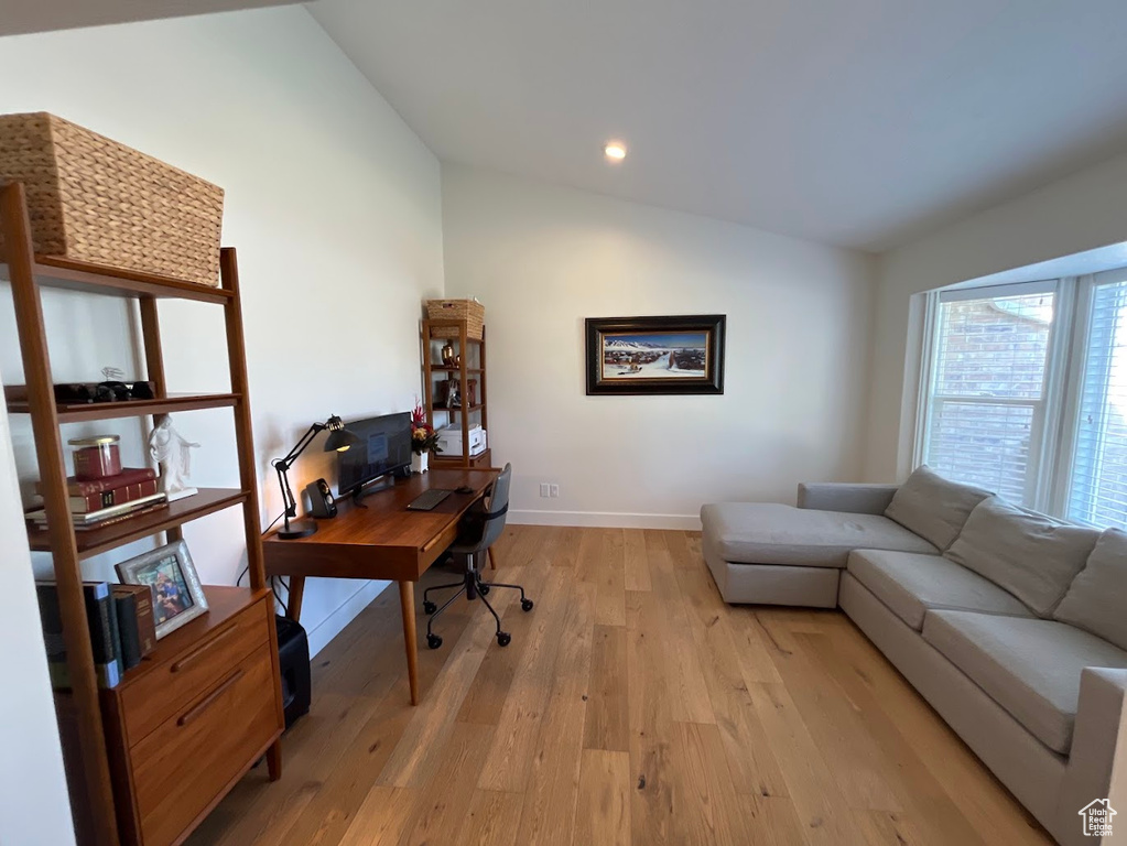 Office area featuring recessed lighting, baseboards, vaulted ceiling, and light wood-style flooring