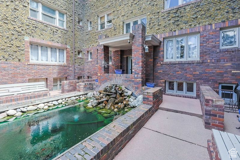 View of pool with a small pond