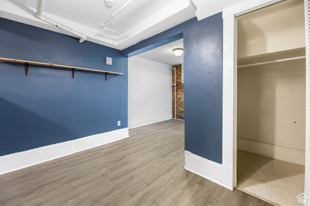 Interior space featuring baseboards and wood finished floors