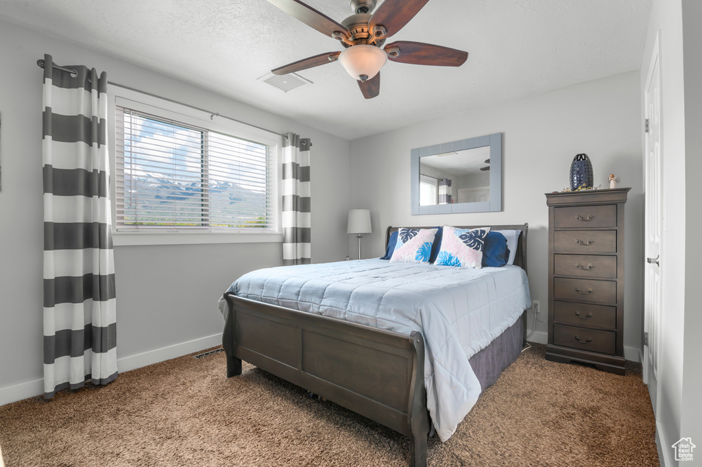 Bedroom featuring visible vents, carpet, baseboards, and a ceiling fan