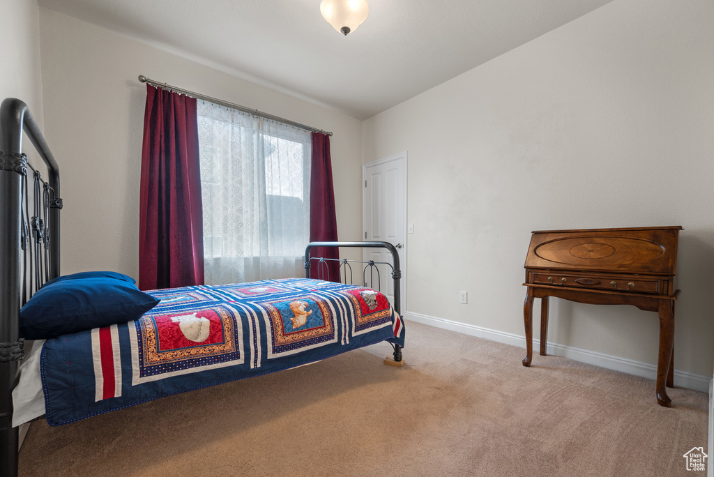 Carpeted bedroom with baseboards
