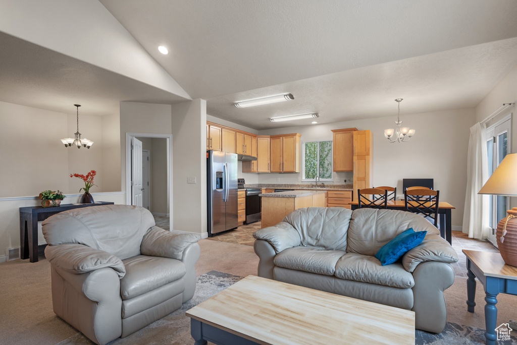 Living area with a notable chandelier, light carpet, and baseboards
