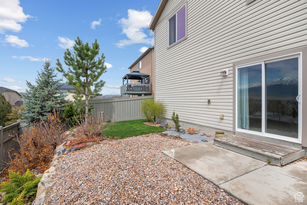 View of yard with fence and a patio area