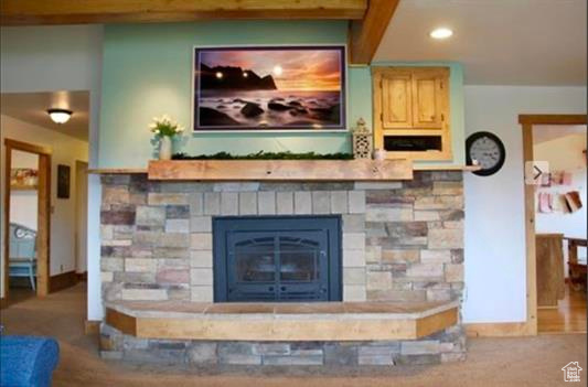 Room details featuring recessed lighting, baseboards, and a fireplace