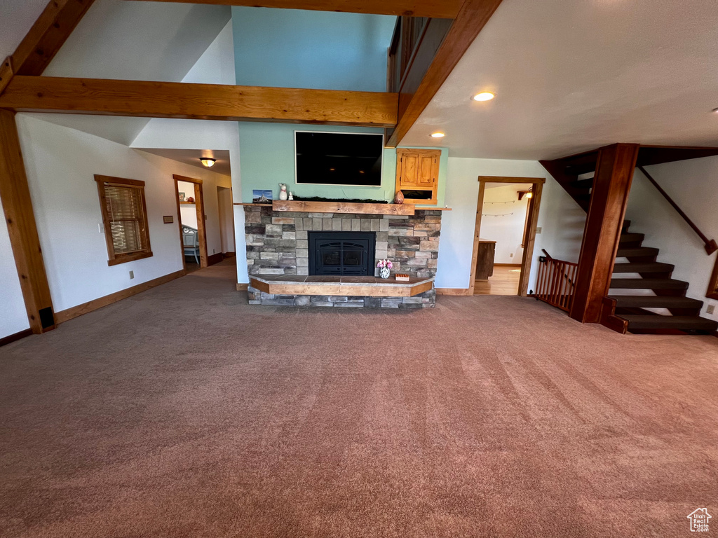 Unfurnished living room with carpet, baseboards, a fireplace, stairway, and recessed lighting