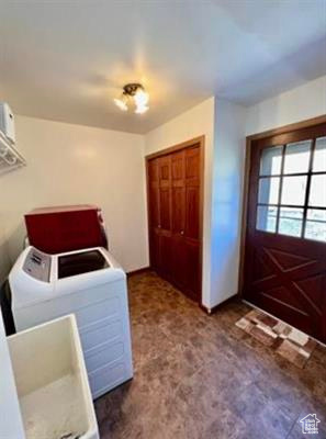 Laundry room with laundry area, washer / dryer, and carpet