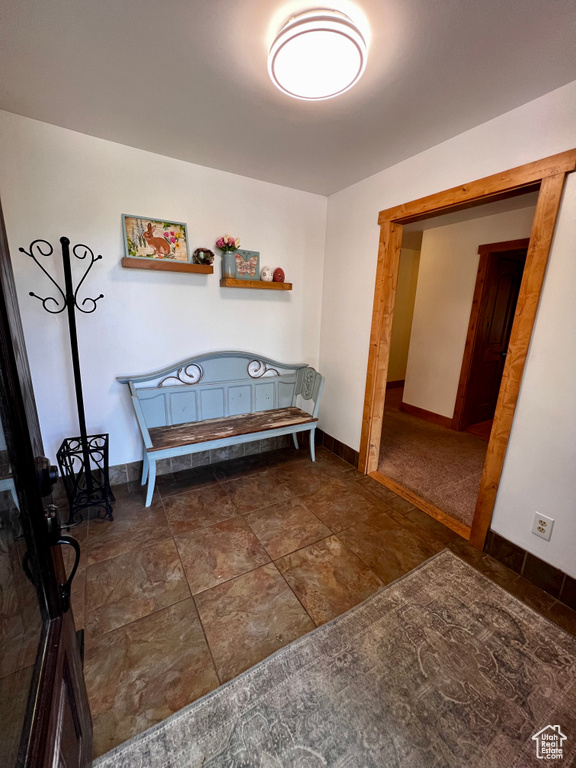 Sitting room with baseboards and stone finish flooring
