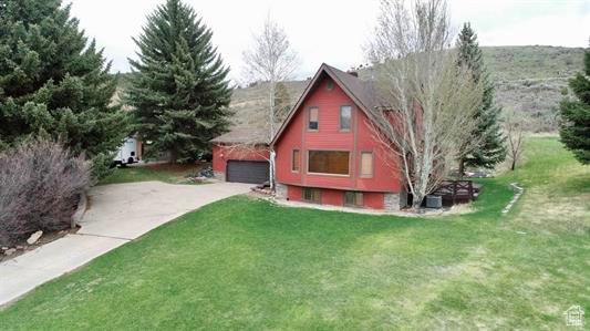 View of outbuilding featuring concrete driveway and a garage