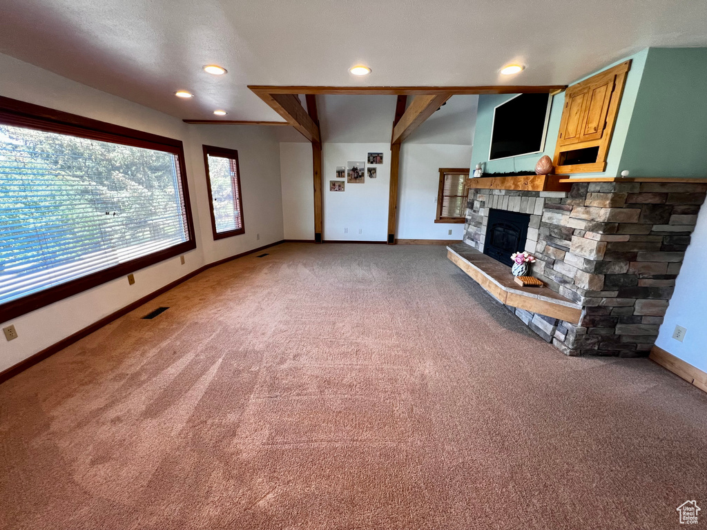 Unfurnished living room featuring light carpet, baseboards, a fireplace, and recessed lighting