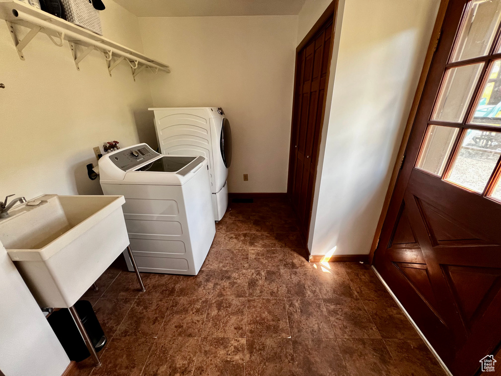 Laundry room with separate washer and dryer and baseboards