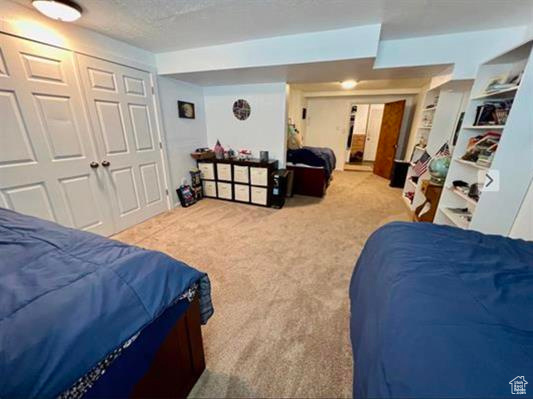 Carpeted bedroom featuring a closet