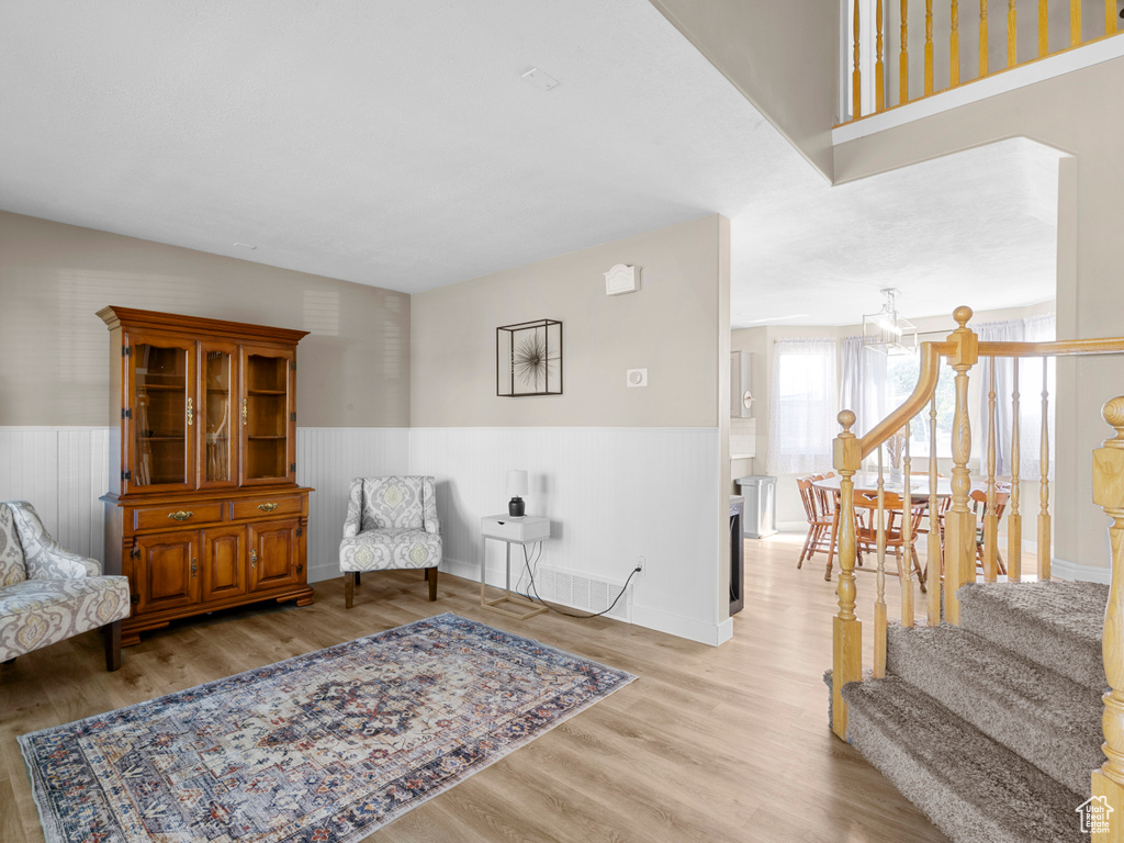Sitting room with wainscoting and light wood-type flooring