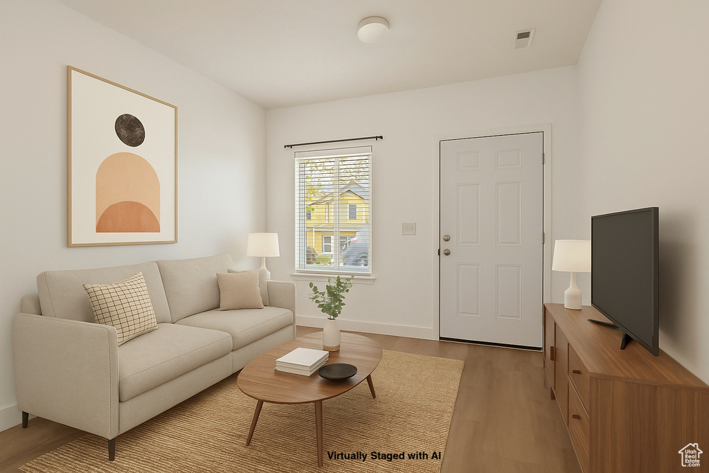 Living room featuring baseboards and light wood-style flooring