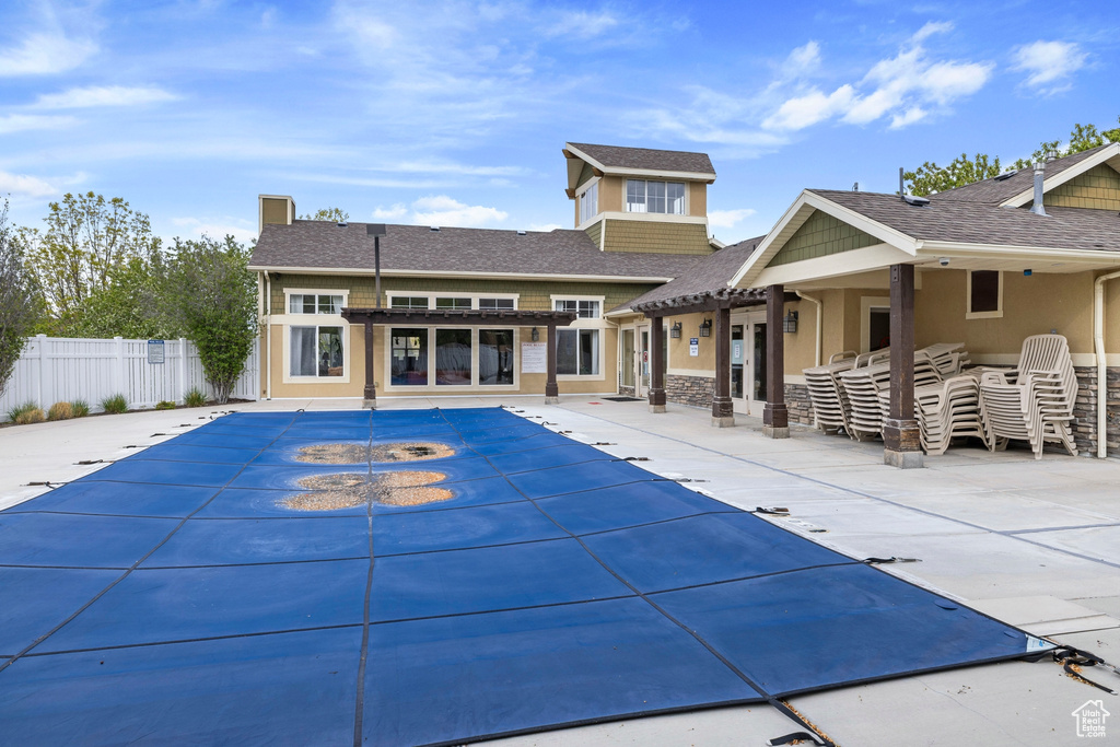 View of pool with fence, a fenced in pool, a pergola, and a patio area