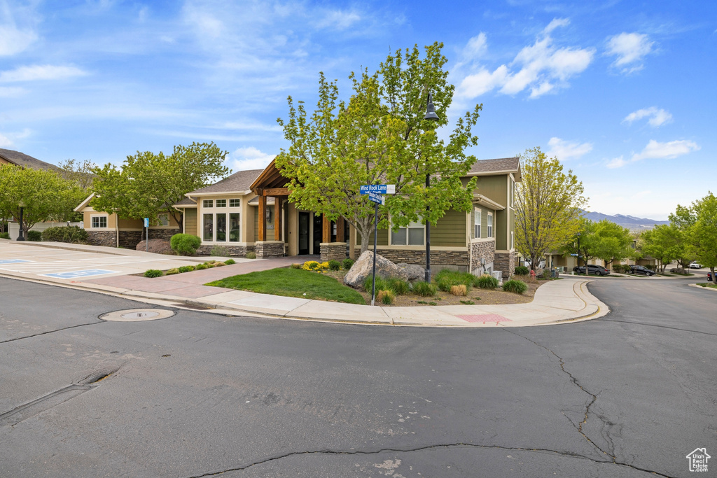 View of front of home with a mountain view and stone siding