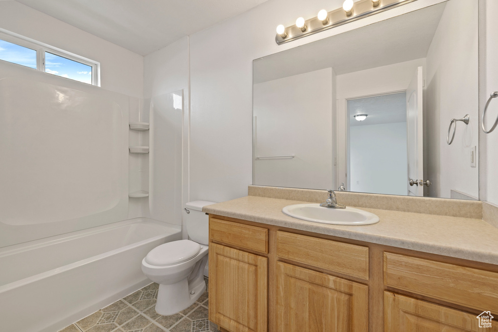 Full bathroom featuring vanity, tile patterned floors, shower / bathtub combination, and toilet