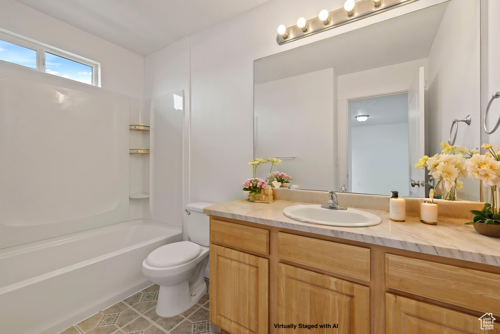 Bathroom with toilet,  shower combination, tile patterned flooring, and vanity