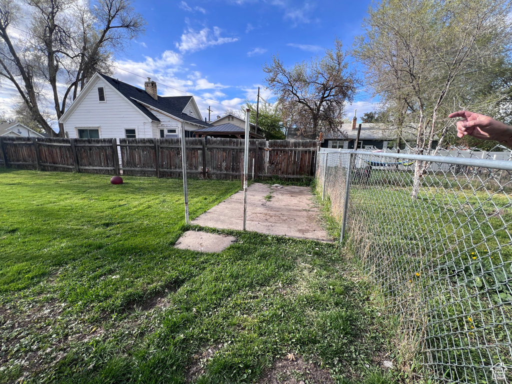 View of yard featuring a fenced backyard and a patio area
