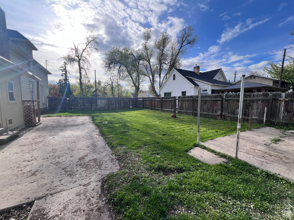 View of yard with a fenced backyard and a patio area