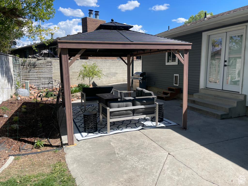View of patio / terrace with french doors, a gazebo, fence, outdoor lounge area, and entry steps