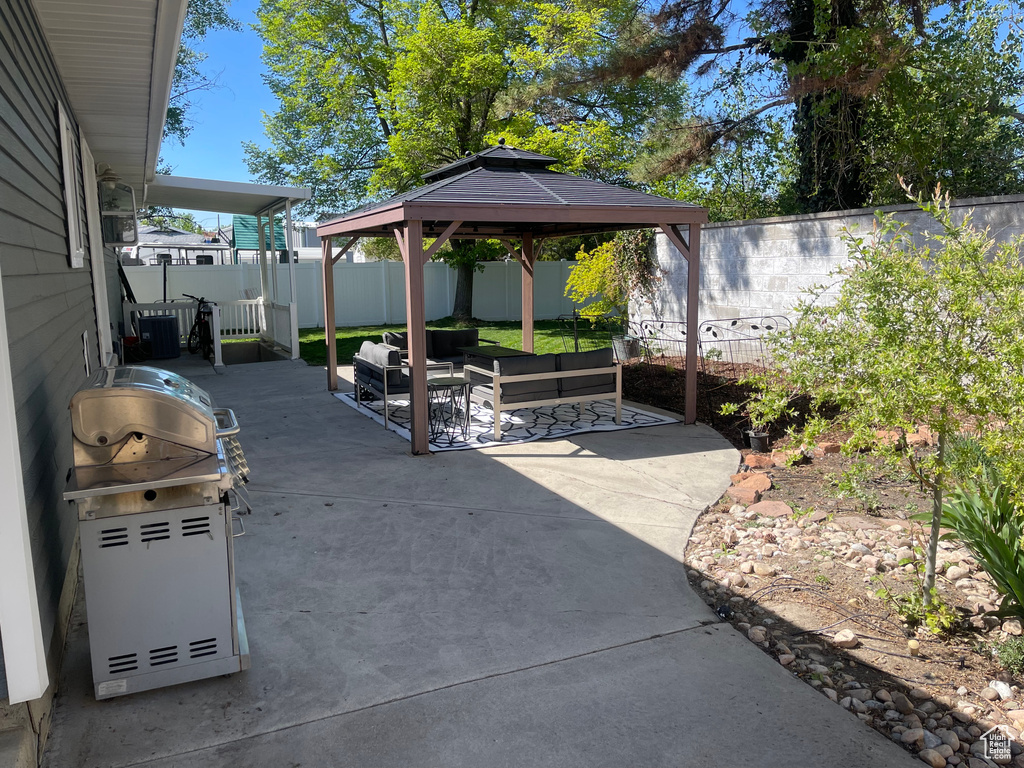 View of patio / terrace featuring a gazebo, an outdoor living space, and a fenced backyard