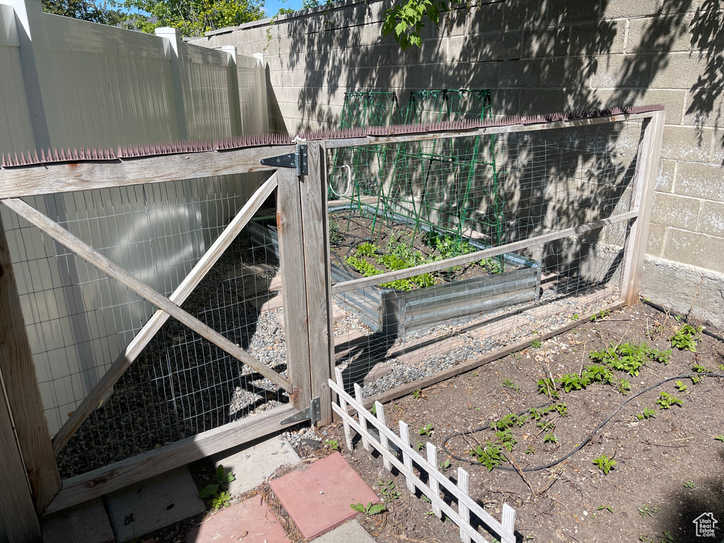 View of gate with exterior structure and fence