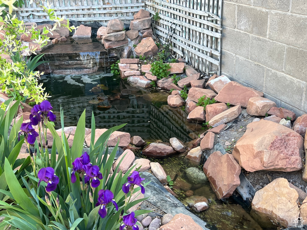 Details with concrete block siding and a small pond