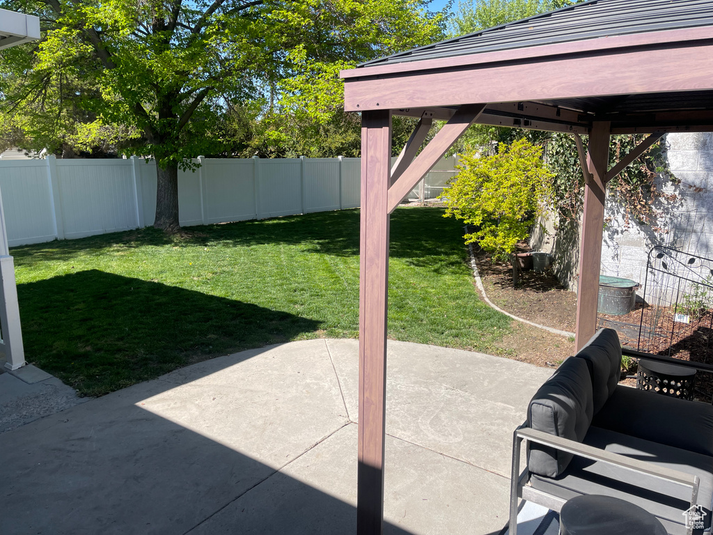 View of yard featuring a fenced backyard and a patio area