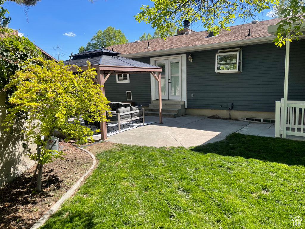 Back of house featuring a gazebo, outdoor lounge area, entry steps, a patio, and a yard