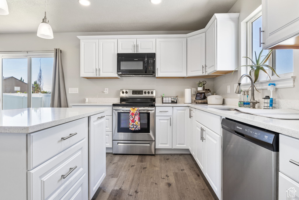 Kitchen featuring recessed lighting, light wood finished floors, white cabinets, and stainless steel appliances