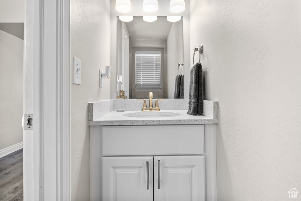 Bathroom featuring vanity and wood finished floors
