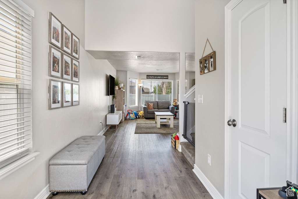 Hall with baseboards and wood finished floors