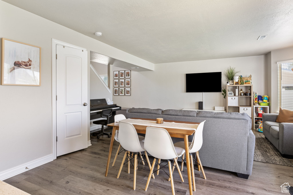 Dining space featuring baseboards and wood finished floors