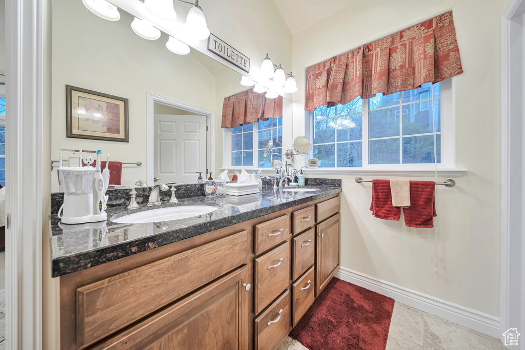 Bathroom featuring double vanity and a sink