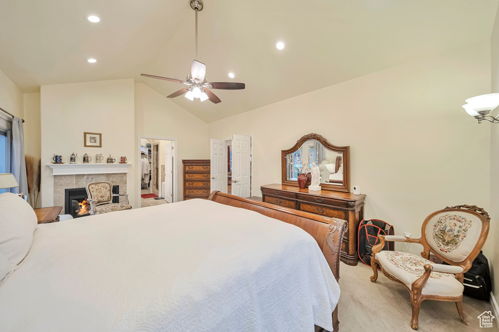 Bedroom featuring carpet flooring, ceiling fan, a tile fireplace, recessed lighting, and high vaulted ceiling