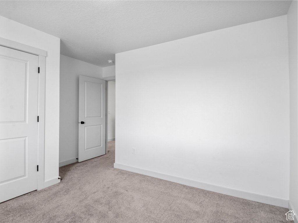 Unfurnished bedroom featuring carpet floors and baseboards