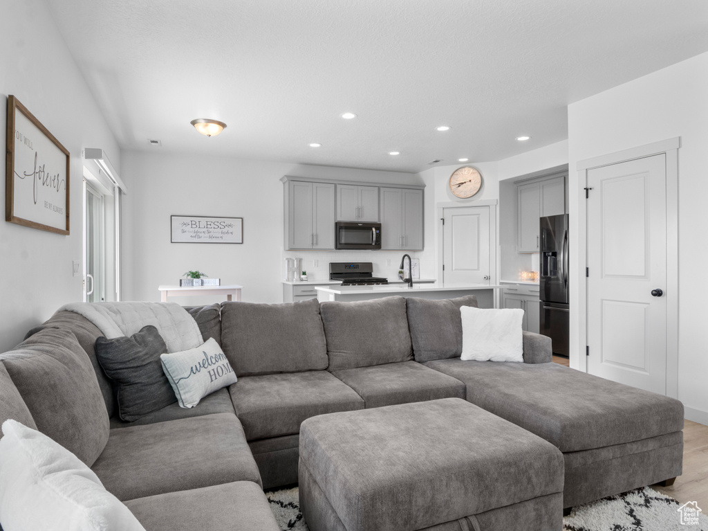 Living room featuring recessed lighting and light wood finished floors