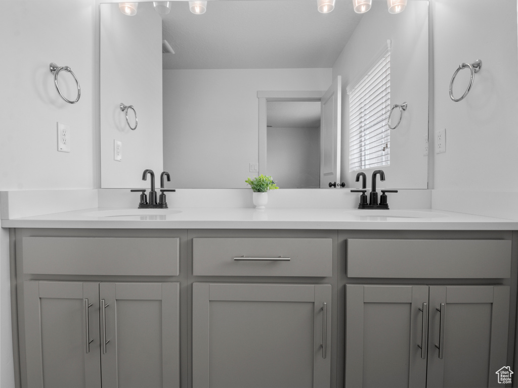 Full bath with double vanity and a sink