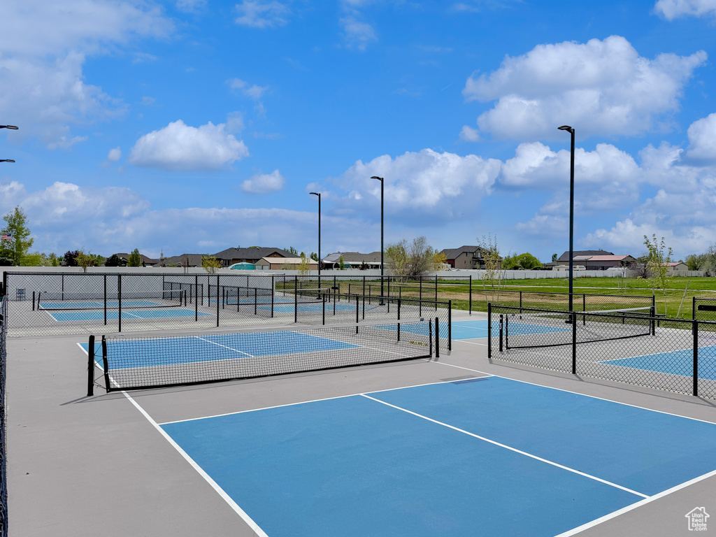 View of sport court with fence and a residential view
