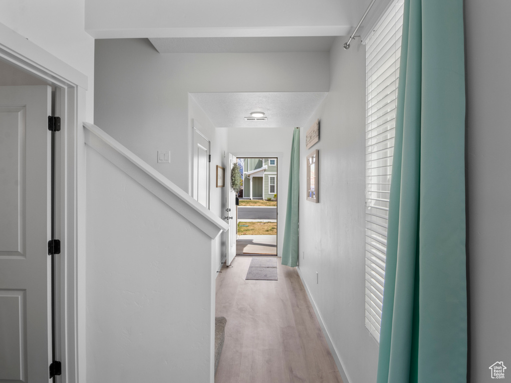 Hallway with light wood-type flooring